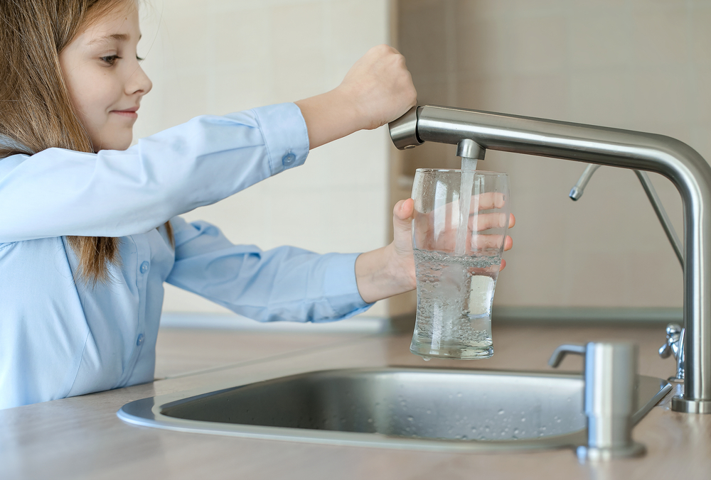 Little,Girl,Opens,A,Water,Tap,With,Her,Hand,Holding